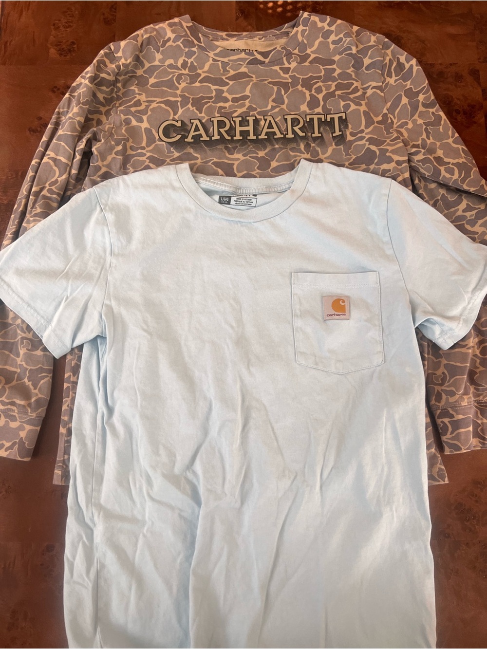 Carhartt Light Blue Pocket Tee with Logo Patch and long sleeve camo tee